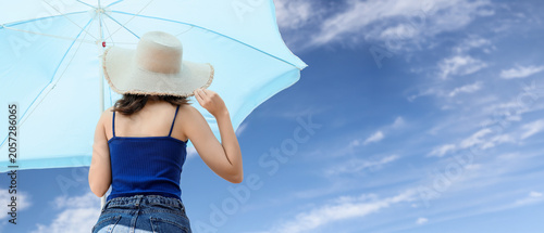 Young woman in straw hat an...