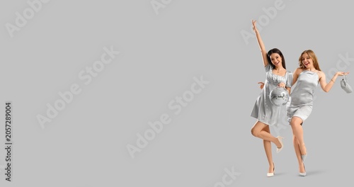 Two cheerful young women in...