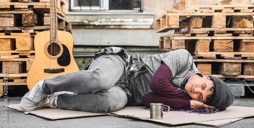 Obraz na plátne Young homeless man sleeping on street