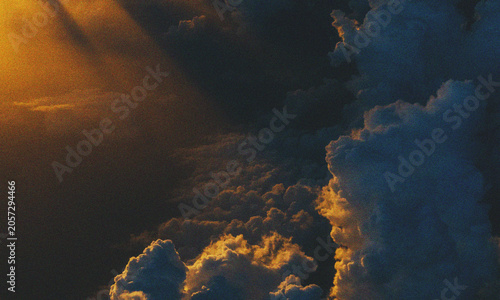 Beautiful sunset clouds glowing in the dark blue sky