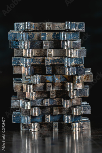 Oxidized nonferrous metal sheet components covered with natural patina and arranged in an abstract stack on a metal surface, metallurgy, recycling and industrial material processing
