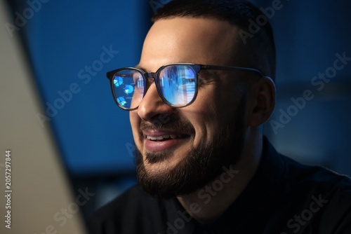 Smiling young man wearing g...