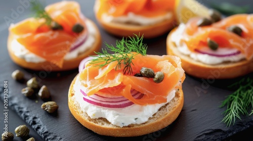 A perfectly toasted sesame bagel is generously spread with smooth cream cheese and topped with delicate folds of bright orange smoked salmon, briny capers