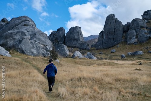 A man running in Kura Tawhiti (Castle Hill), New Zealand