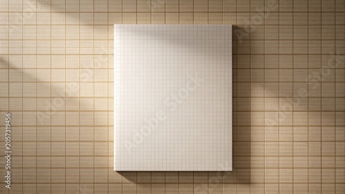 Blank Gridded Paper Notebook Mockup Against a Textured Background in Warm Sunlight
