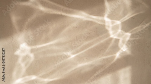 Aesthetic beige plaster wall background with soft water ripple shadow projection. Minimalist organic caustic mockup banner.
