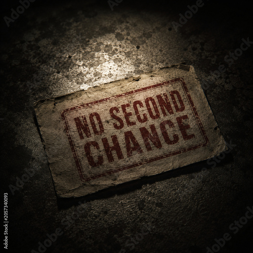 No second chance stamped paper on cracked concrete conveying consequences and accountability in dim light with worn texture and dramatic mood