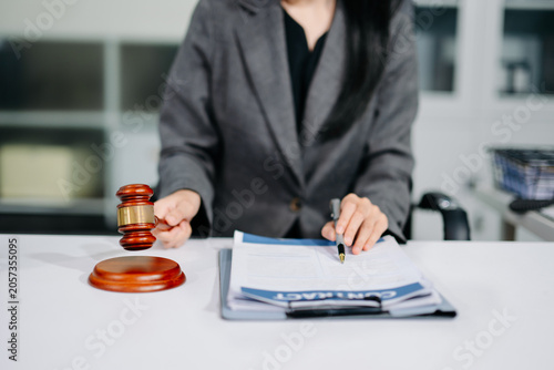 justice and law concept. Male judge in a courtroom the gavel, working with smart phone and laptop and digital tablet computer on white table