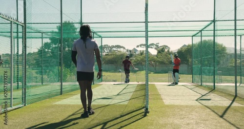 Indian male bowler jogging into a3 lane practicing underarm bowls to nets, teenage player charging