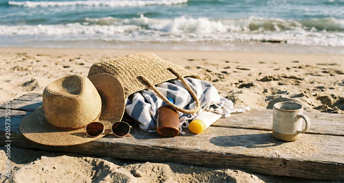 Beach Essentials Still Life with Straw Hat, Sunglasses and Bag on Sandy Shore