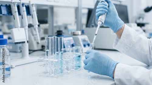 Scientist working in laboratory setting carefully.