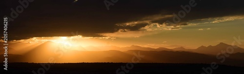 striking golden sunset  panorama of long's peak and  the front range of the colorado rocky mountains, as seen from broomfield, colorado