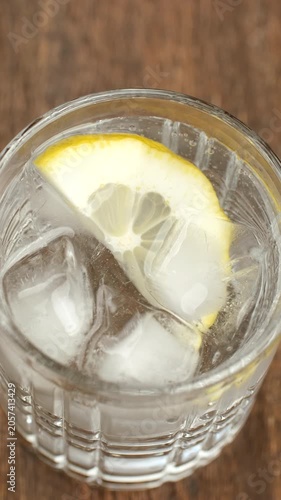 Refreshing sparkling water with lemon in glass