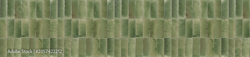 Fotografía Panoramic banner of olive green ceramic tiles arranged in a vertical pattern for rustic kitchen backsplash wall decoration