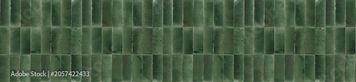 Fotografie Panoramic banner of deep emerald green ceramic tiles arranged in a vertical pattern for luxury interior wall decoration