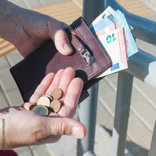 Fotografía Leather purse, euro banknotes and coins in female hands, selective focus
