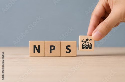 Net Promoter Score (NPS) measuring customer satisfaction and loyalty concept.Tool for measure customer loyalty and improvement products or services. Wooden cube blocks with NPS text and icon.