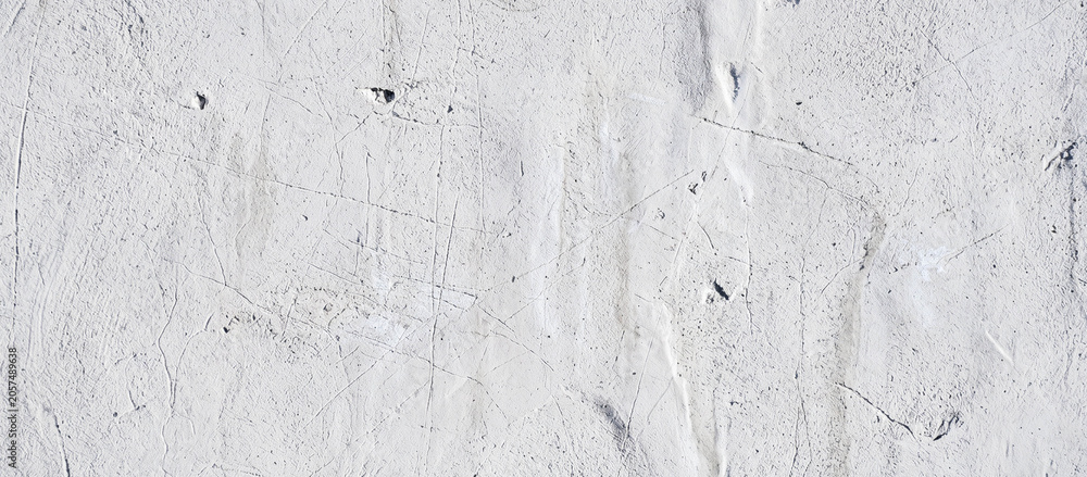 Fototapeta premium A textured surface featuring warm tones of orange and brown, resembling aged plaster or a natural stone wall, ideal for backgrounds or artistic projects.