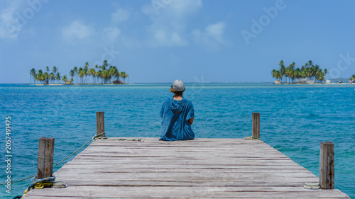 Photos Guna Yala, Panama. Woman sitting in a pier enjoying tropical view