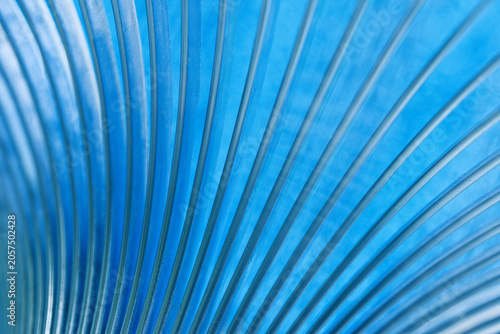 Close-up of sweeping blue curves creating a dynamic abstract pattern. High-resolution technological backdrop ideal for modern corporate and industrial layouts. Photo