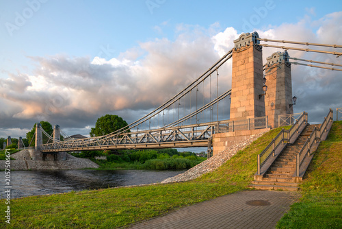 One of the spans of the ancient suspension bridge over the Velikaya River in the historical center of Ostrov, Pskov Region, Russia
