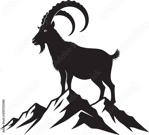 goat standing on mountain peak silhouette