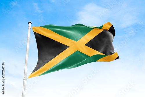 Canvas Print Jamaica national flag waving against blue sky