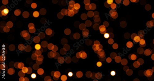 An elegant seamless animation features glowing blurry dust particles floating dynamically. The chaotic shimmering bokeh dots move forward to form a beautiful overlay design.