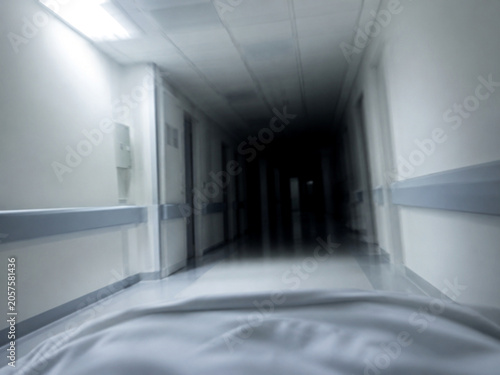 Hospital corridor fading to darkness, blurred perspective of consciousness fading