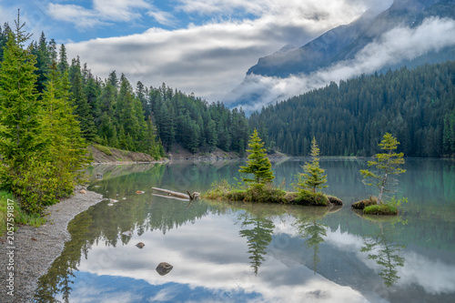 Three spruce trees on tiny islands in Two Jack Lake in Banff National Park, Alberta, Canada
