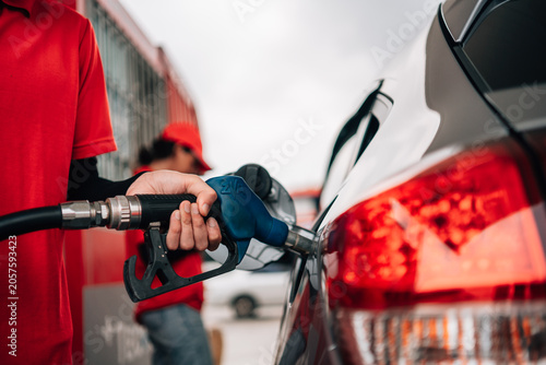 Obraz na plátně Close-Up of Gas Station Attendant Pumping Fuel into Car