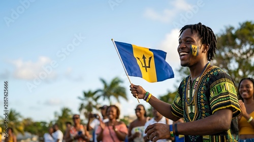 Happy barbadian man waving national flag at outdoor celebration