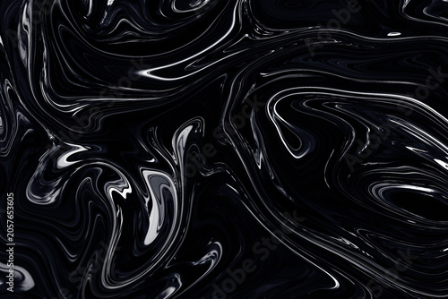 Swirling and shiny black material that looks like oil, latex, leather, plastic, satin or fluid. Abstract high resolution luxurious and glamorous background with metallic highlights.