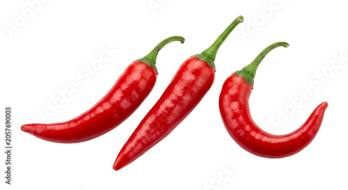 Obraz na płótnie Three vibrant red chili peppers with green stems on a clean white background
