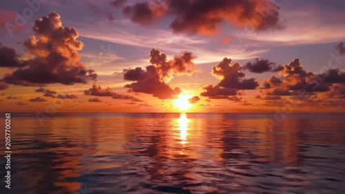 Stunning sunset over the ocean reflecting vibrant colors in the sky and calm water