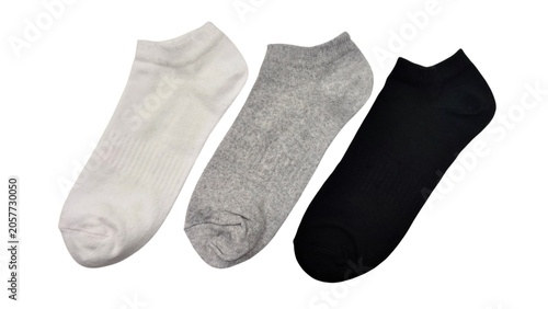 Top view of three pairs of low-cut ankle socks in white, gray, and black colors, isolated on white background.