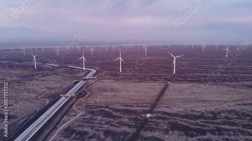 Aerial view of wind farm and long road across barren landscape