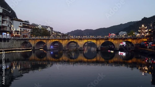 Illuminated stone arch bridge at dusk in Fenghuang Ancient Town, China in Fenghuang Ancient Town, Hunan, China
