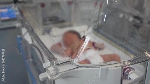 Newborn Baby in an Incubator With Medical Equipment.Empty infant incubator in an hospital room. Specially equipped room with newborn babys sleeping in incubators in the Obstetrics and Gynecology Hospi