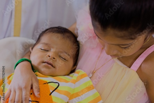 Sister cares for baby brother in cozy setting