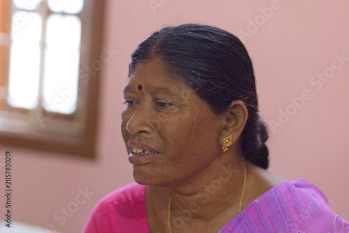 Woman sitting indoors with natural light in her home
