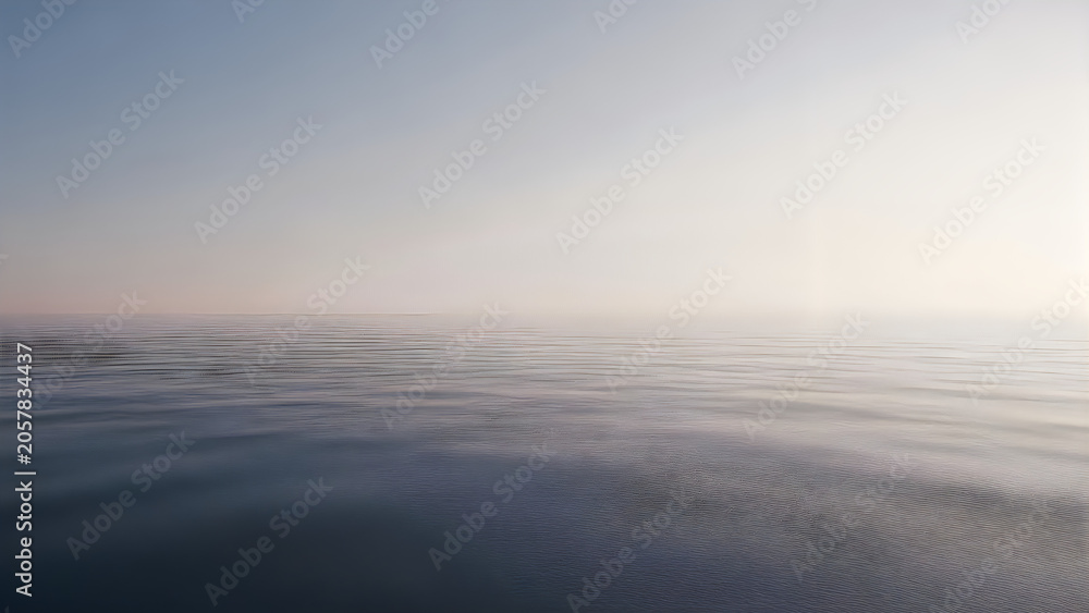 Fototapeta premium Serene ocean water with gentle ripples at sunrise or sunset with clear sky