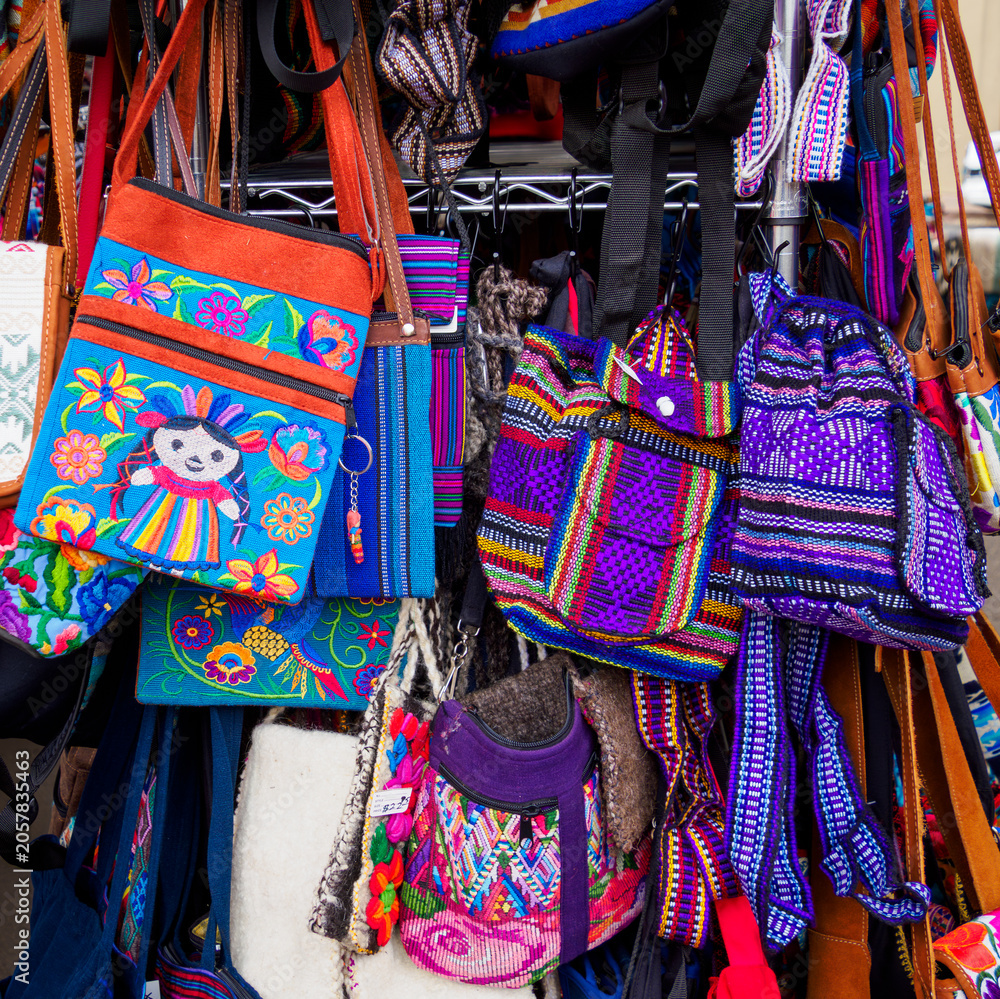 Obraz premium Fabric bags for sale at a roadside mall in Santa Fe, NM, with bold floral and other embroidered designs