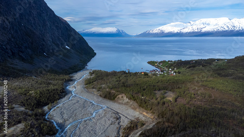 drone shot in the Lyngen Alps with the village of Koppangen in Norway