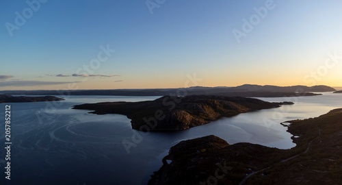 drone shot of midnight sun over Bokfjord near Ropelv in South Varanger, Northern Norway