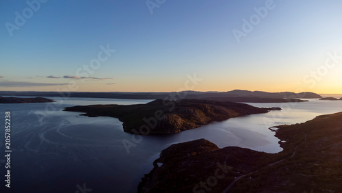 drone shot of midnight sun over Bokfjord near Ropelv in South Varanger, Northern Norway
