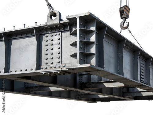 Industrial construction site metal beam with lifting equipment and hooks, detailed close-up of large steel structure used in building assembly and manufacturing