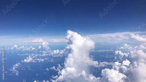 Photography A view of fluffy white clouds in a blue sky from above
