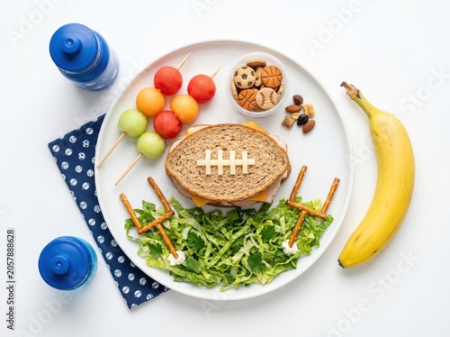Healthy plate with sandwich, salad, fruit, and nuts