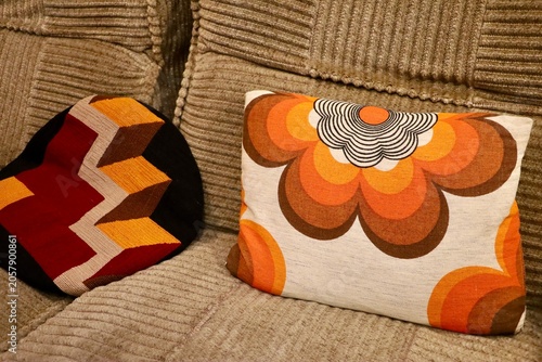 Картината върху платно Decorative cushions arranged on a vintage sofa create a warm and inviting interior inspired by the 1970s
